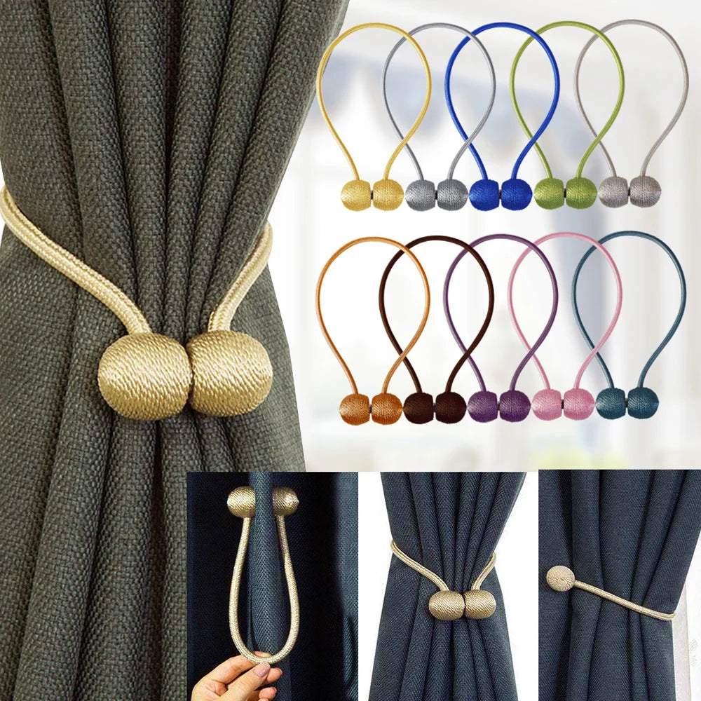 "deux boules blanches avec cordes décoratives" (two white balls with decorative ropes) could be a simple keyword for this image. it captures the main elements of the picture while also suggesting a certain elegance and visual appeal.