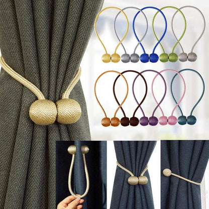 "deux boules blanches avec cordes décoratives" (two white balls with decorative ropes) could be a simple keyword for this image. it captures the main elements of the picture while also suggesting a certain elegance and visual appeal.