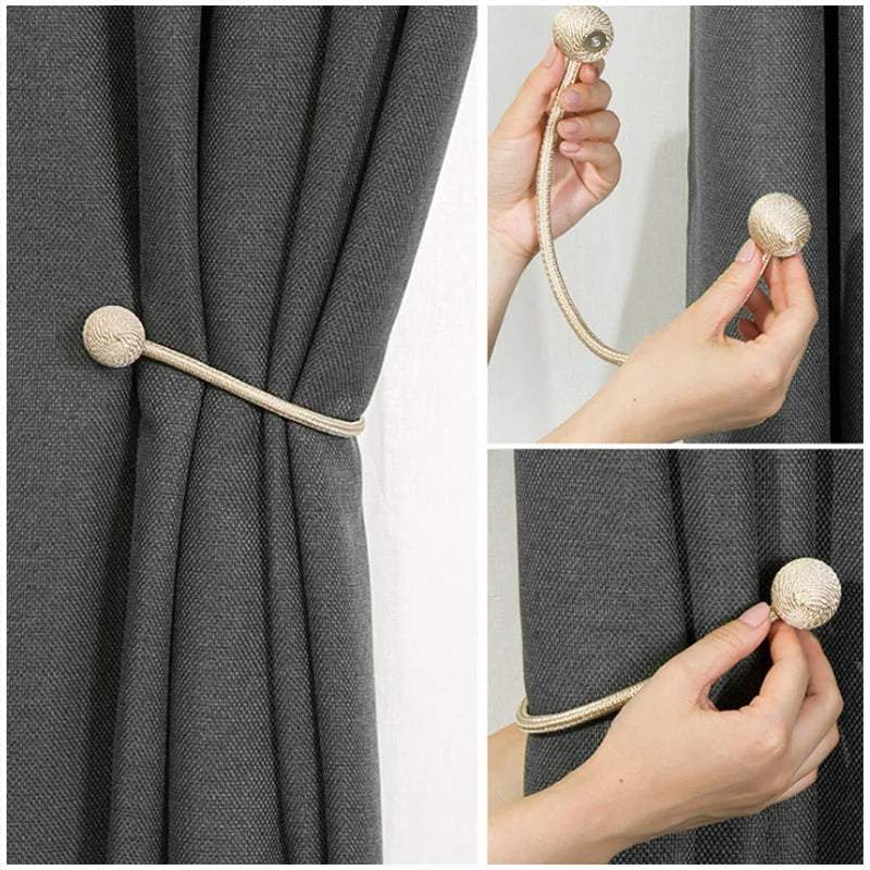 "deux boules blanches avec cordes décoratives" (two white balls with decorative ropes) could be a simple keyword for this image. it succinctly describes the main elements of the picture while also suggesting its decorative nature.